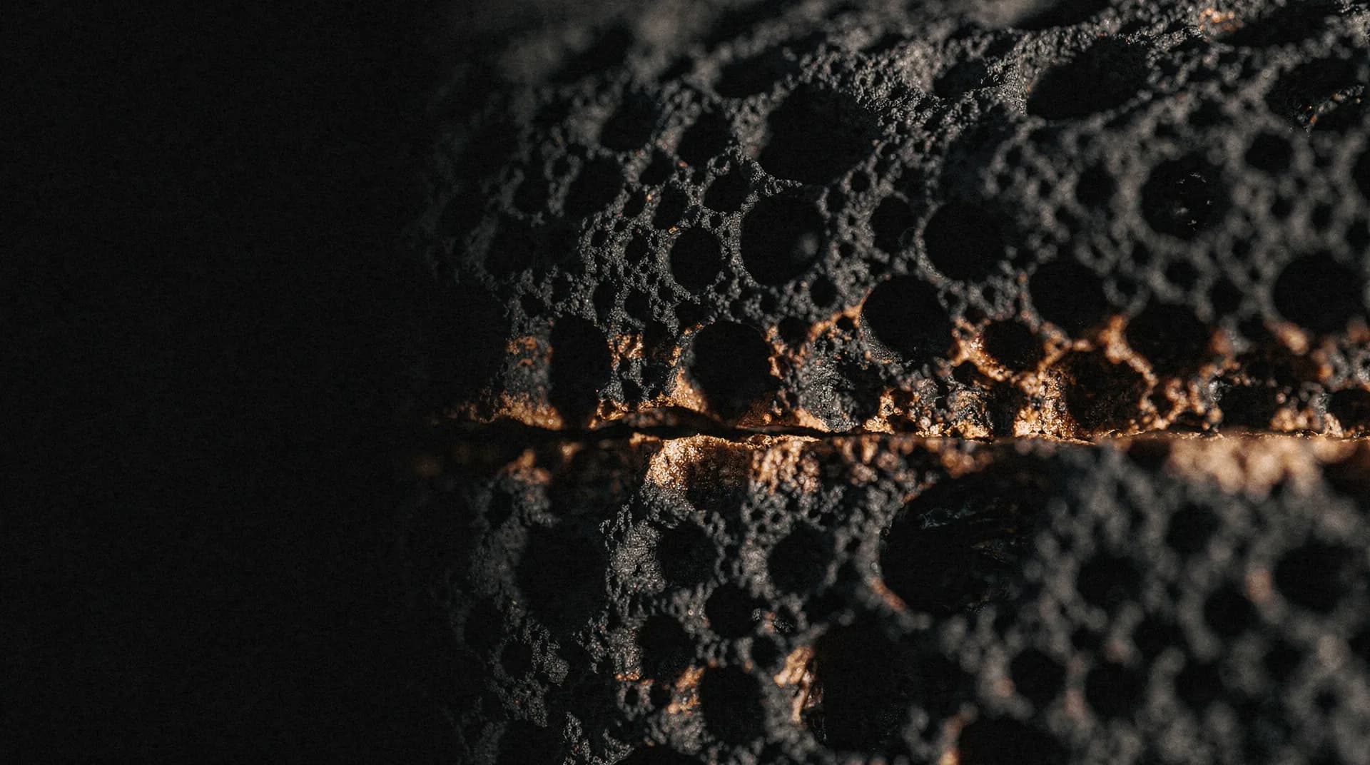 Macro of a dark porous foam structure